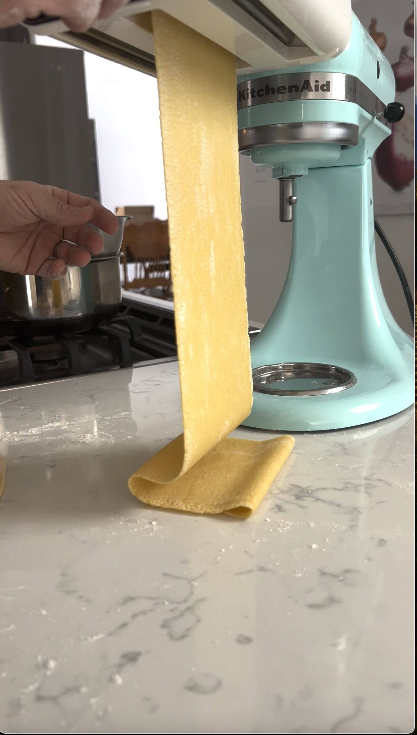 Pasta going through a pasta maker.